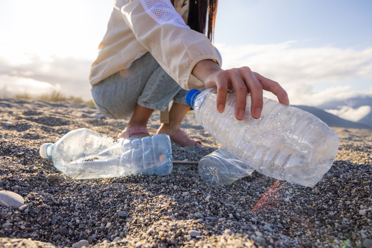 Volunteer pick plastic bottle trash at beach